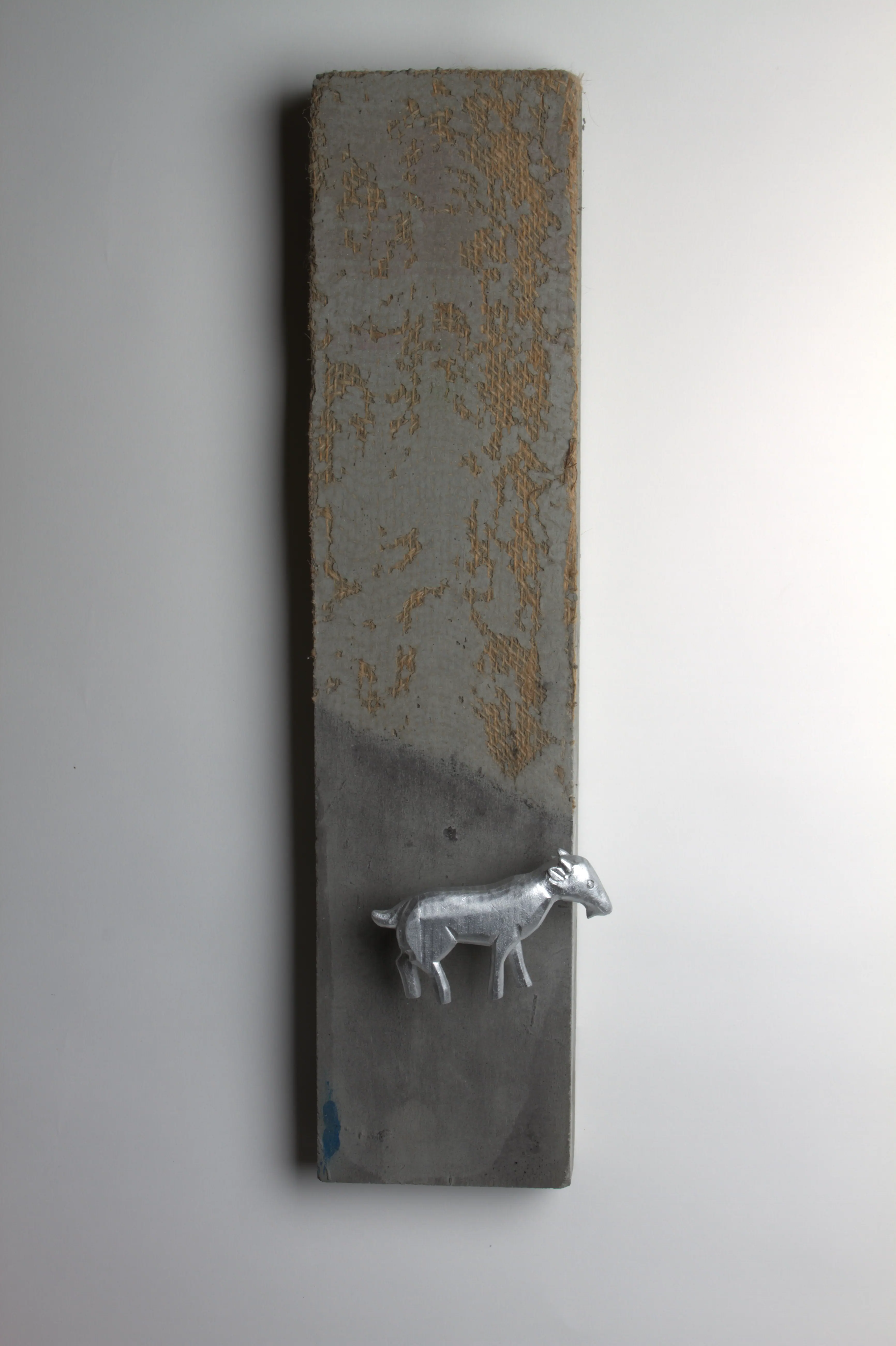 Burlap sky with grazing silver goat concrete wall sculpture