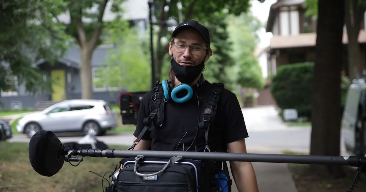 Adam Biel holding sound equipment
